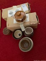 Lot overview showing boxes, lidded crock and stacked bowls