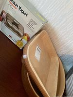 Box of Braun Yogurt maker and two nested tan stoneware pieces