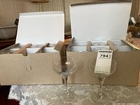 Two boxes of Rosenthal coupe glasses and two examples displayed