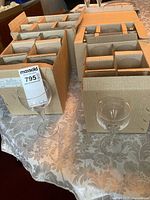 Boxes of partitioned stemware with one goblet displayed