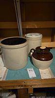 Group of two crocks, one jug, lids
