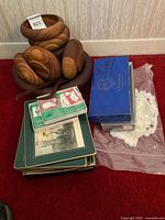 Group view of wooden bowls, placemats stack, gift label boxes, candle box