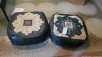 Both leather footstools showing tops and sides