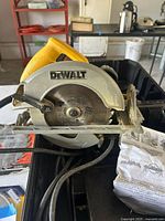 Photo of yellow and silver DeWalt circular saw with blade, showing brand and model info