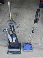 Photo of both vacuums and the electric carpet sweeper showing overall condition and included accessories.