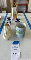Full lot showing all items including two antique ceramic vases, floral cup, white decorative boot, and two Delft windmill salt and pepper shakers