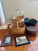 Lot arranged on wooden floor showing all items including baskets, metal coal scuttle, wooden storage box, metal trash cans, and framed prints.