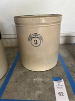 Full view of the beige stoneware crock with blue eagle and number '3' on the front