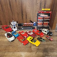Overview of loose diecast cars and police car toy on floor