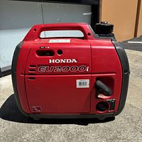 Front view showing Honda EU2000i logo, integrated handle and engine switch