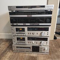 Full stack of 5 vintage audio components including Sony CD/DVD player on top, Magnavox tuner and amplifier, two Technics M14 cassette decks, and Hitachi stereo receiver at bottom.