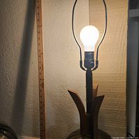 Close-up of one lamp showing harp, socket and wood accent with measuring ruler in background indicating height ~30 inches