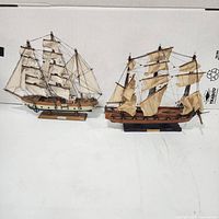 Two model sailing ships Fragata Espanola and Gorch Fock side by side, showing full rigging and sails