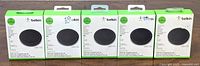 Front view of 5 boxed Belkin Boost Up Wireless Charging Pads 5W in new condition