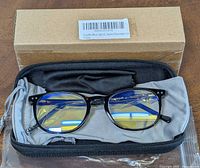 Blue light blocking eyeglasses with tortoise frame in a black zippered case with cleaning cloth and packaging box