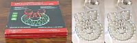 Front view of box and two silver metal LED silhouette wreaths with multicolor lights with Christmas designs.