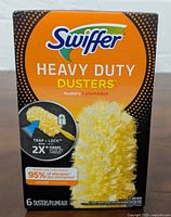 Front view of Swiffer Heavy Duty Dusters packaging showing six dusters, product name, and key performance features.
