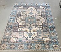 Full view of traditional Bohemian area rug with medallion pattern and multi-tone color palette including blue, cream, grey, and beige.