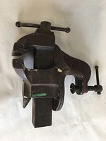 Front angled view of vintage table clamp-on vise showing jaw and handle details.