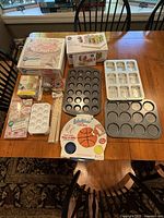 Overview of the baking and decorating supplies spread on the table, showing pans, cutters, and decorating tools.