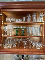 Full cabinet of mixed glassware including wine, margarita, rocks, shot, cocktail glasses