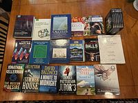 Full lot of 17 books and 1 DVD box set arranged on table, showing covers and spine details.
