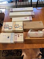 Photo of all shelving units in original boxes arranged on a table including floating and wall shelves