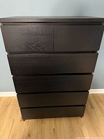 Front view of tall 5-drawer chest showing five spacious drawers with black-brown wood veneer.