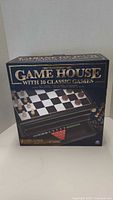 Front photo of Traditions Game House box showing the 10 classic games and image of the tiered game storage box with game boards and pieces.