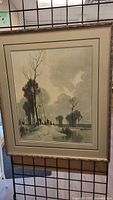 Full view of framed print artwork showing landscape scene with trees and river.