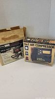 Photo showing both the 3-in-1 air compressor box and the Craftsman electric drill box.
