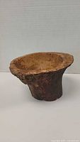 Front and top angle view of hand carved arbutus wood bowl showing inner surface and bark on outer base.