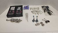 Photo of assorted jewelry including shoe accessories in boxes, brooch, earrings, and rhinestone necklaces displayed on white background.