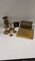 Lot displayed showing brass weights, etched vase, black box and brass boxes