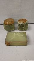 View of the three items showing two onyx green paperweights and one rectangular box