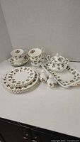 Full set of Royal Albert bone china Winsome pattern cups, saucers, plates, salt and pepper, sugar bowl, and tray arranged for display