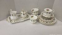 Royal Albert tea set arranged including milk jug, covered sugar bowl on serving tray, 4 cups, 4 saucers, and 4 side plates
