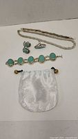 Full set of sterling silver and turquoise jewelry including ring, earrings, two bracelets, necklace, and storage pouch.