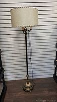 Full view of the vintage floor lamp showing the brass and alabaster base and fabric shade
