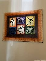 Full view of Belize canvas painting with six symbols in a brown textured border.