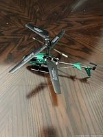 Top angle showing the overlapping dual main blades and tail rotor with stabilizers