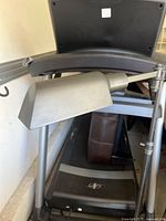 Close-up of the rectangular adjustable lamp head showing the brushed brass finish and articulation joint.