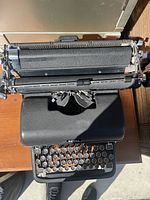 Top-down view of the black Royal manual typewriter showing the round keys, platen, and typebars.