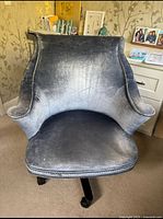 Front view of blue grey upholstered desk chair showing fabric condition and design.