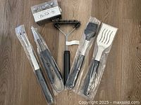 All five BBQ utensils in plastic sleeves plus boxed thermometers
