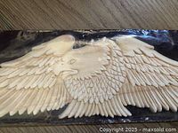 Close-up of carved wood eagle details in packaging