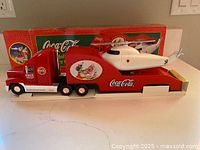 Right side view of truck and helicopter with box background