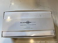 Boxed set showing GlucksteinHome branding and quantity 12 napkins