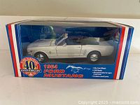 Front view of boxed 1964 Mustang model showing branding and car