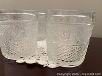 Side view of two glasses showing trellis floral band and diamond pattern
